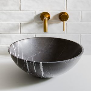 Interiors photography of basin black marble basin and gold taps