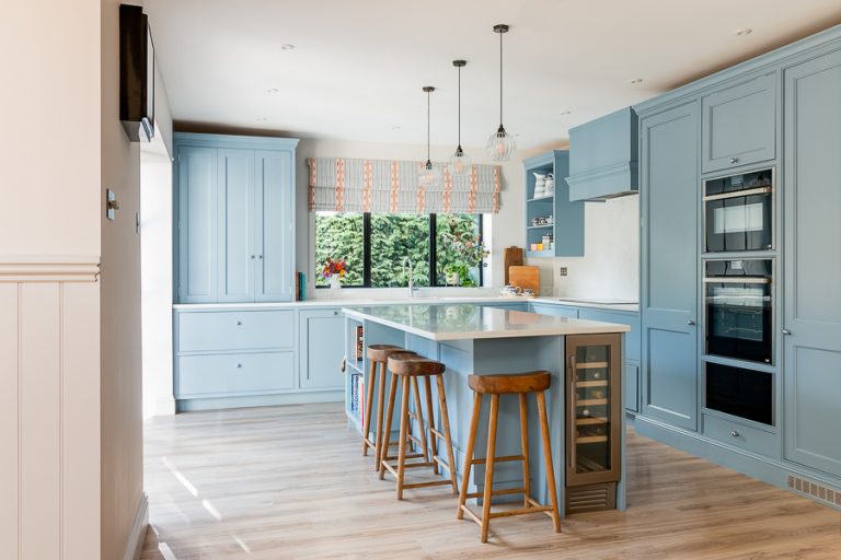 Interiors photography of open plan kitchen- Photo of open plan kitchen with blue units