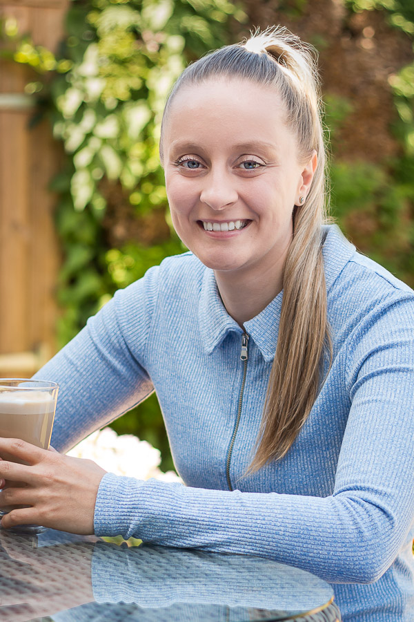 Female headshot in garden drinking coffee