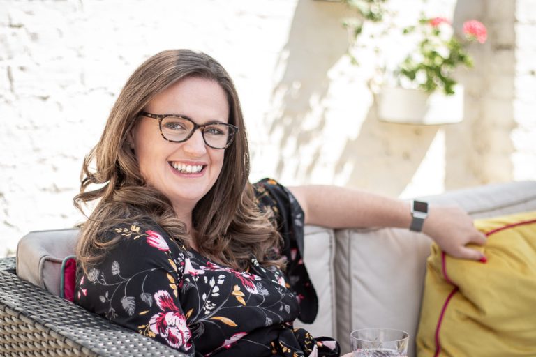 Female headshot in sunny courtyard