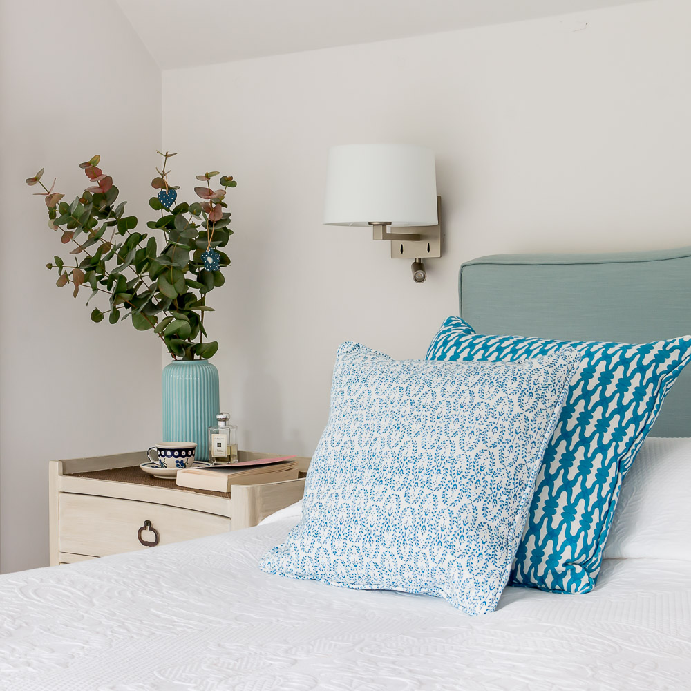 Interiors photography of stylish bed and bedside table