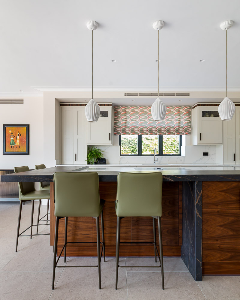 Kitchen photography for Anna Patten Design_Sevenoaks- Portrait photo of luxury kitchen with dark wood island and green high stools