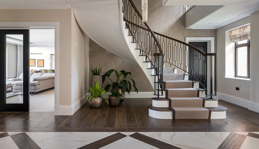 Landscape photo of grand hallway with spiral staircase